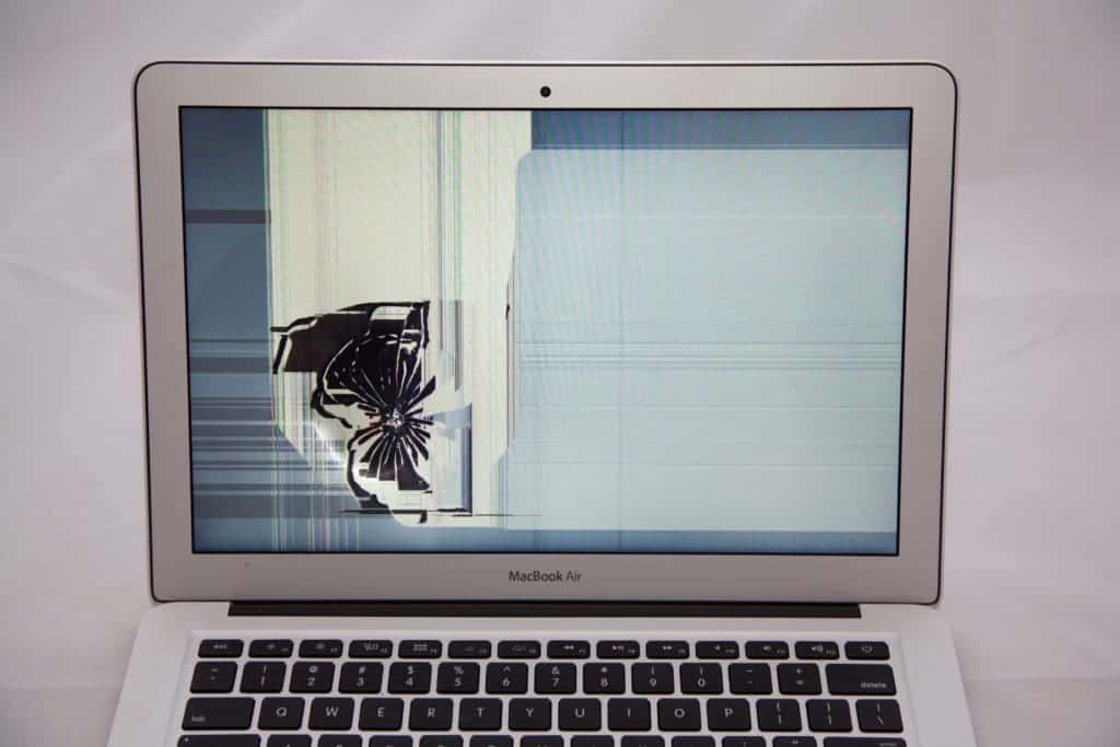 impact damaged MacBook Air Screen with Crack starting on the left side centered from a hard impact radiating outward.