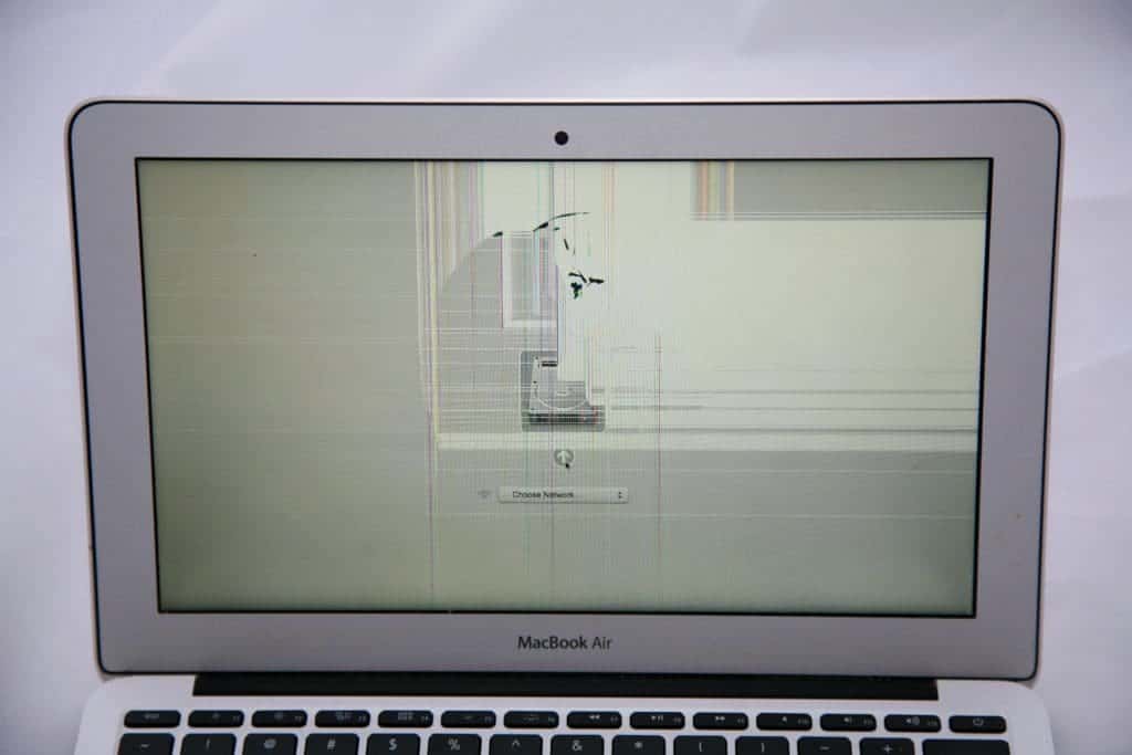 MacBook Air 11" with cracked display directly on the center top of the screen