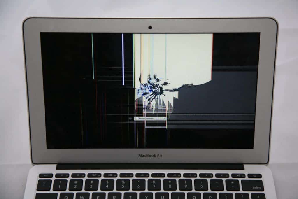 11" MacBook Air with spider web damage from hit to Apple logo on the back of the display