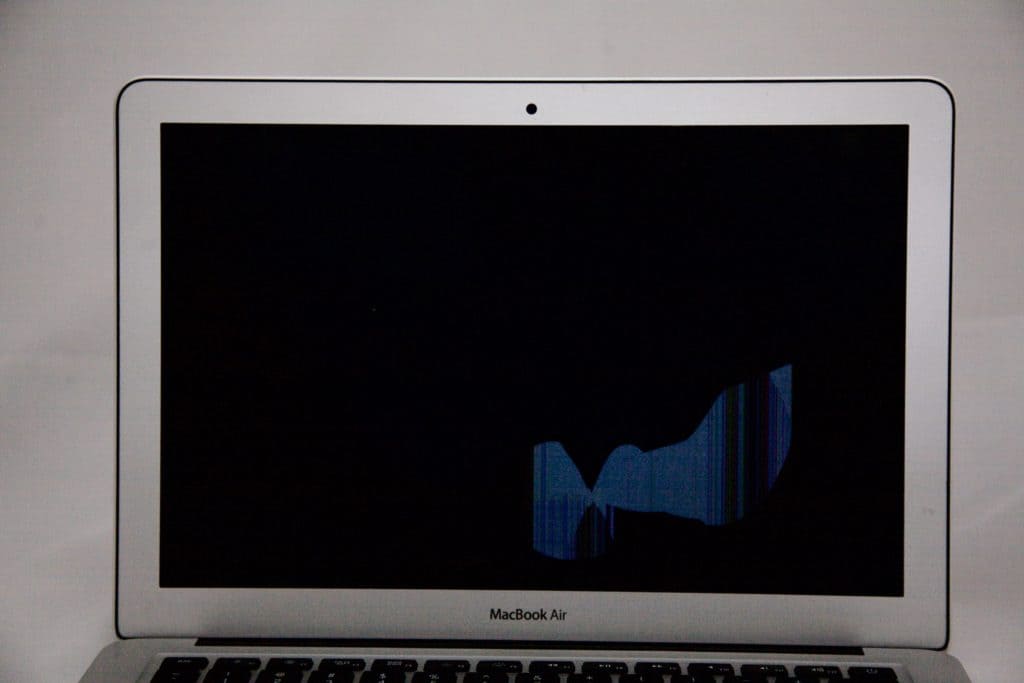 Mostly black screen on MacBook Air with blue discoloration on the bottom right.