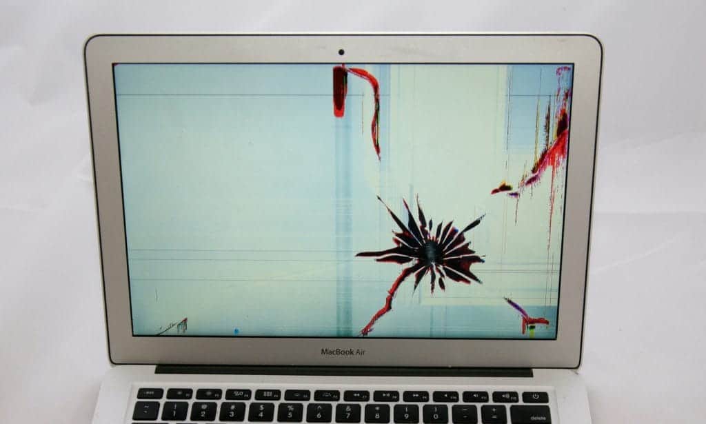 13 inch MacBook Air with crack on bottom right of the screen. causing red and black discoloration including splotches and lines