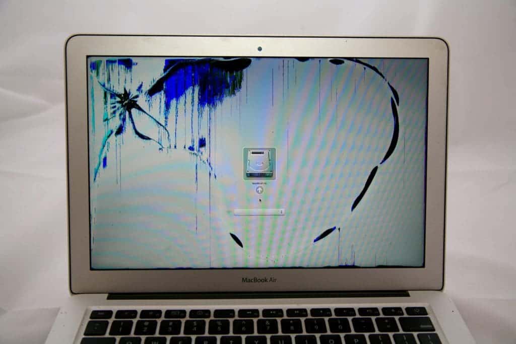 MacBook Air with crack on top left and blue discoloration immolating from center of damage