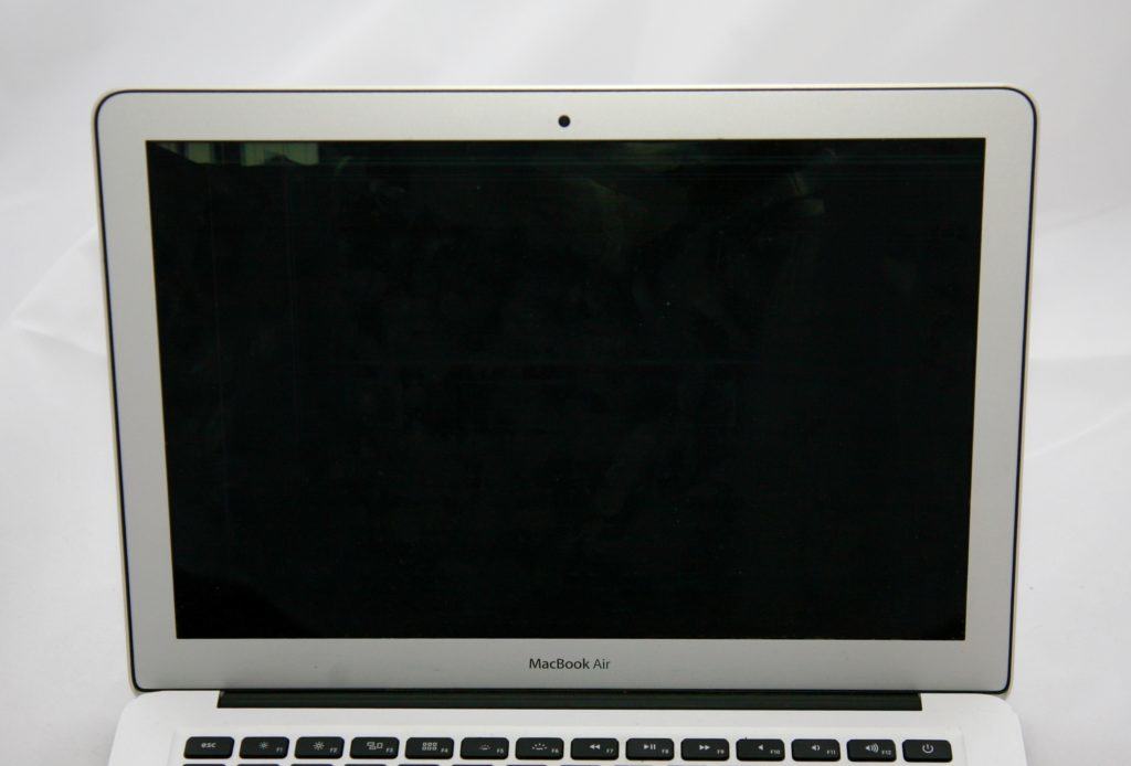 13" MacBook Air with almost complexly black screen. The only visible part of the display is the very top left.