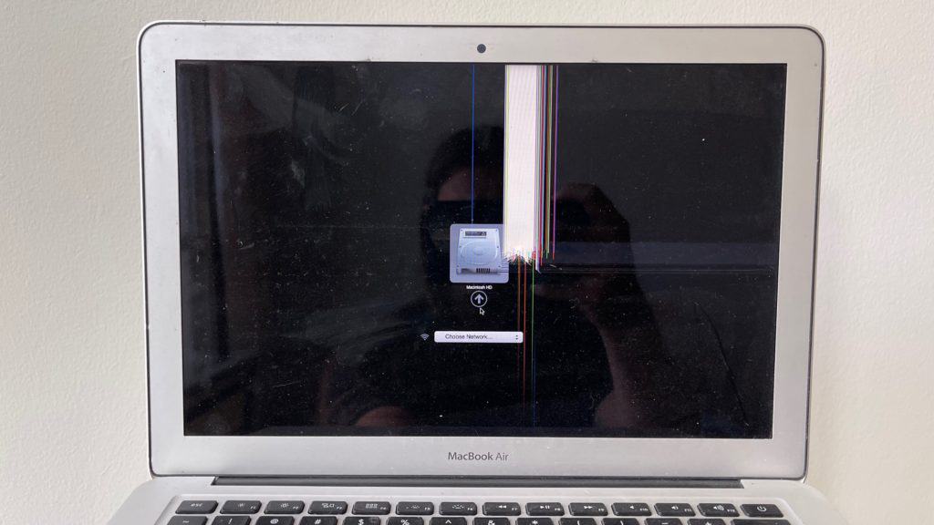 MacBook Air with a crack on LCD panel from an impact on the center of the screen.