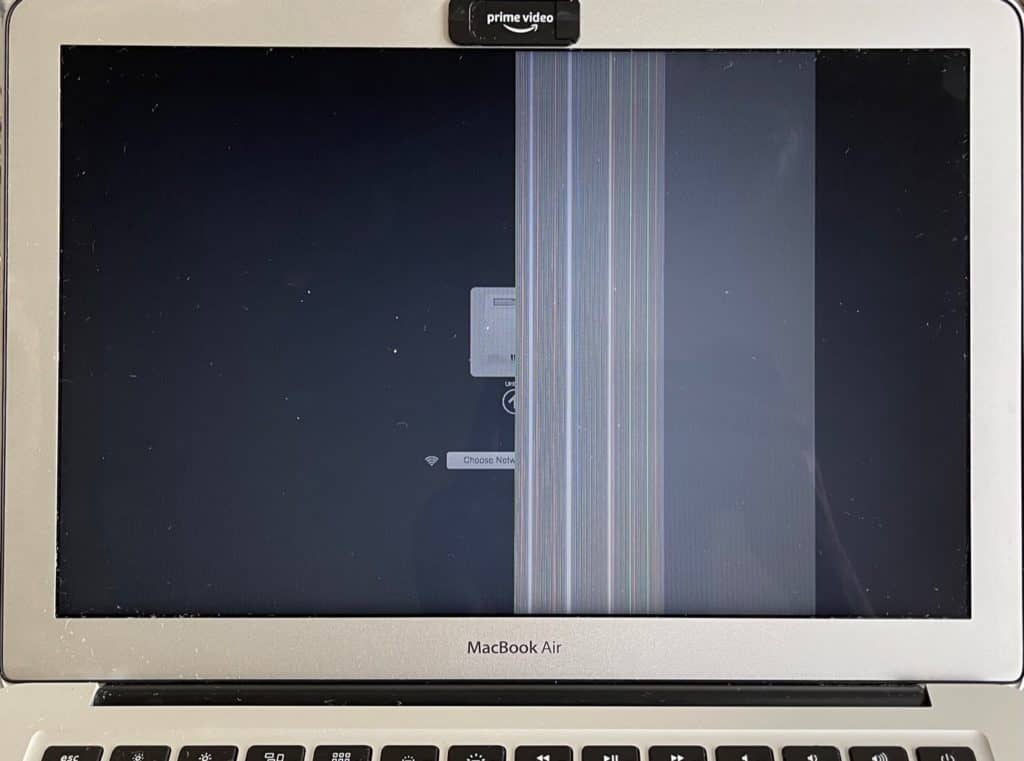 MacBook Air with vertical bar of lines next to a vertical bar of solid white. Bad LCD panel example.