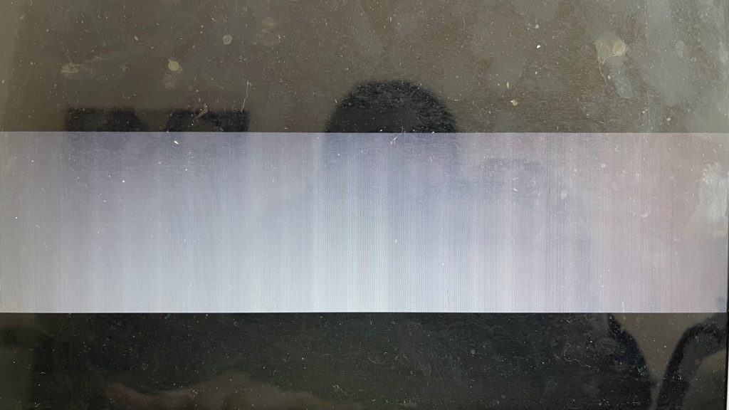 MacBook Air with solid horizontal bar of white an dvertical lines on screen.