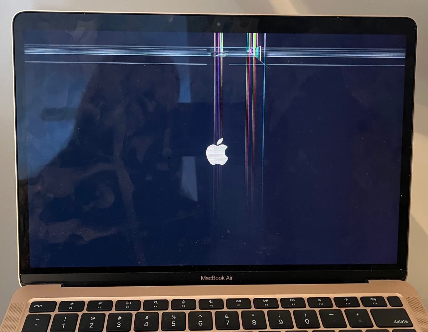 A2337 MacBook air with a hairline crack at the top of the screen causing horizontal and vertical lines.