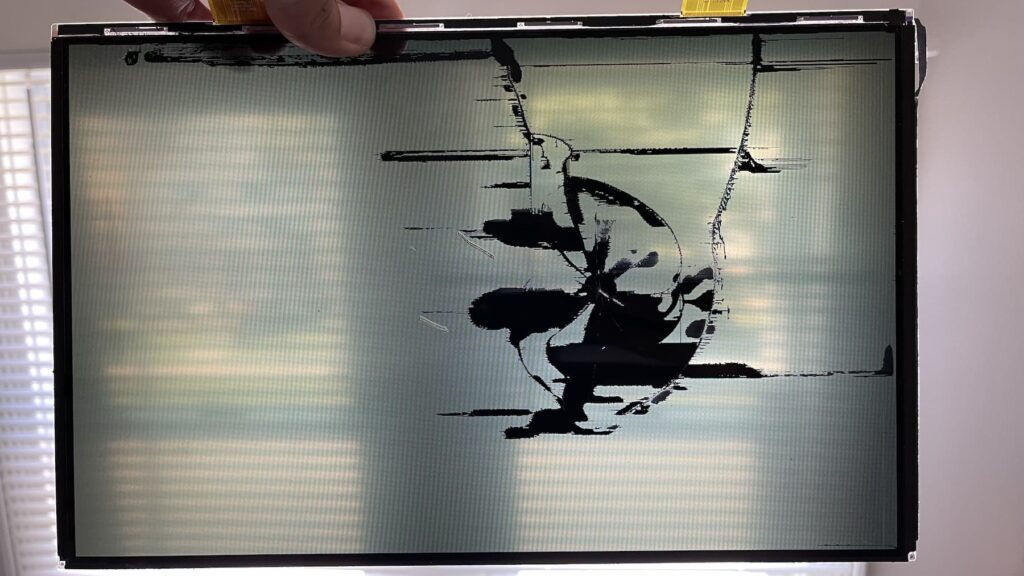 MacBook Air Crushed Screen Repair - White Spots 4 Back of LCD panel showing gouges.